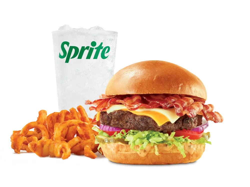 Arby's Big Cheesy Bacon Burger with bacon, American and Swiss cheeses, lettuce, tomato, onions, pickles, and burger sauce on a toasted brioche bun, served with medium curly fries and a medium soft drink.