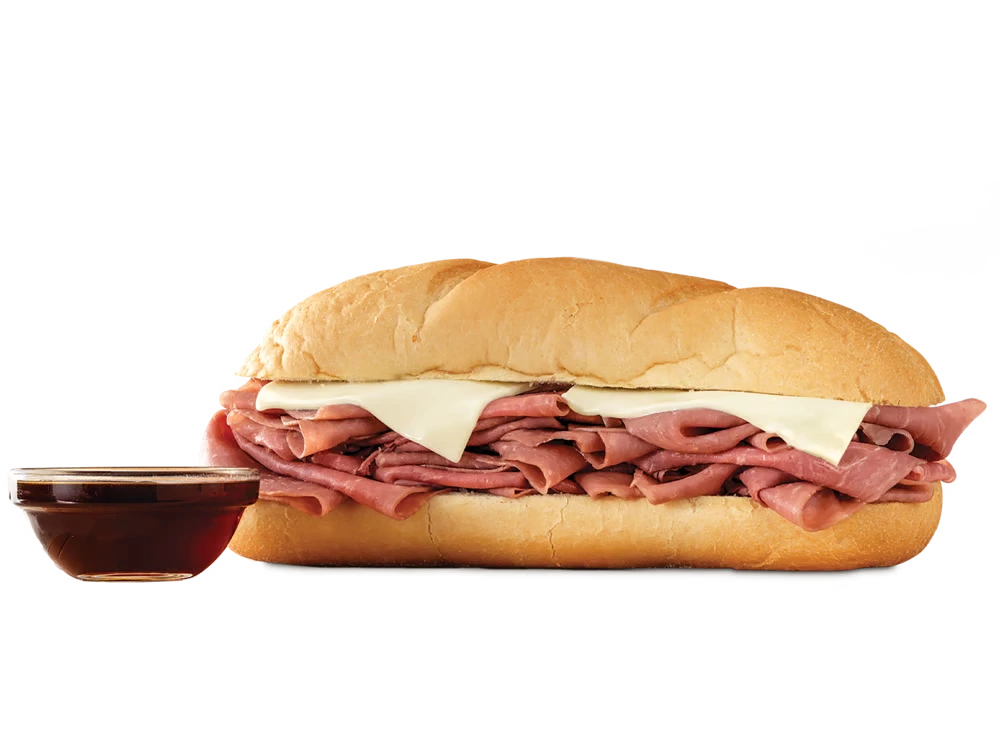 Arby's Classic French Dip & Swiss sandwich with roast beef and melted Swiss cheese on a toasted sub roll, served with a side of au jus.