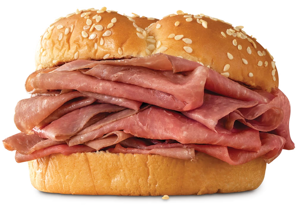 Arby's Classic Roast Beef sandwich with thinly sliced roast beef on a toasted sesame seed bun.