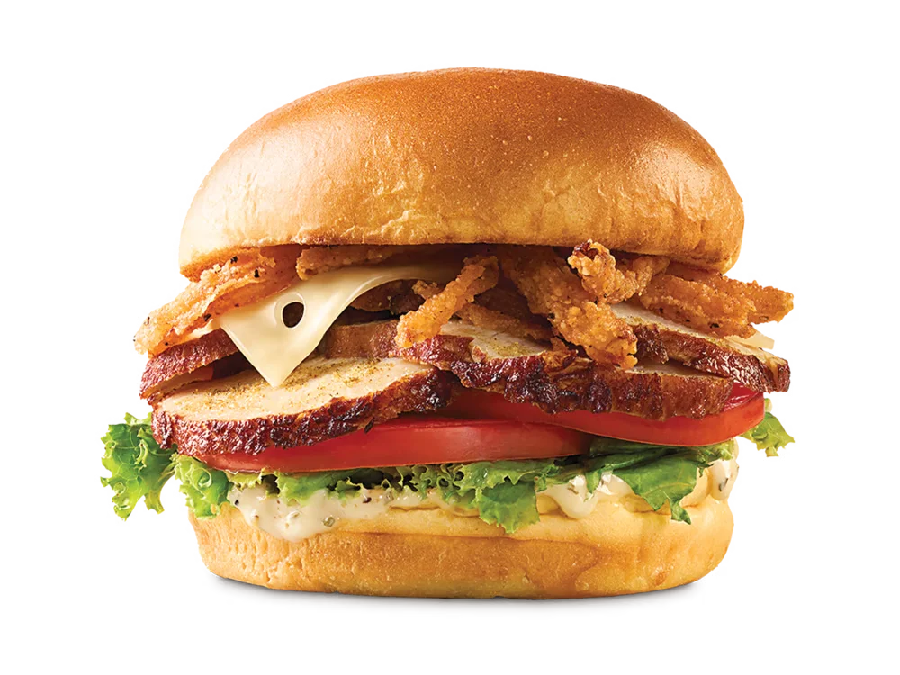 Arby's Deep Fried Turkey Gobbler Sandwich with deep-fried turkey, crispy onions, Swiss cheese, lettuce, tomato, and herb spread on a toasted brioche bun.