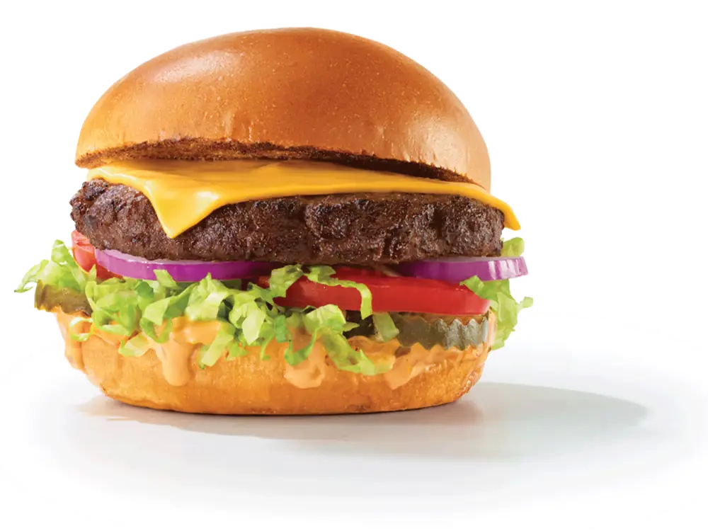 Arby's Deluxe Burger with American cheese, lettuce, tomato, pickles, red onion, and burger sauce on a brioche bun.