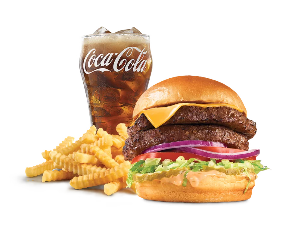 Arby's Double Deluxe Burger with two beef patties, American cheese, lettuce, tomato, pickles, red onion, and burger sauce on a toasted brioche bun, served with medium curly fries and a medium soft drink.