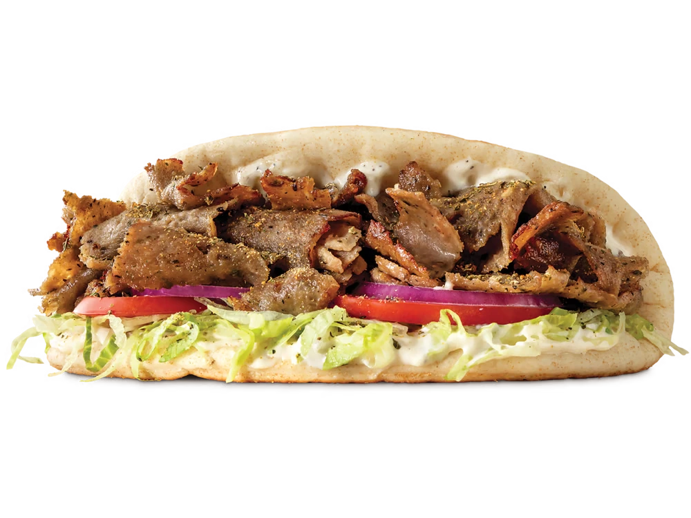 Arby's Greek Gyro with seasoned gyro meat, lettuce, tomatoes, red onions, and tzatziki sauce in warm flatbread.