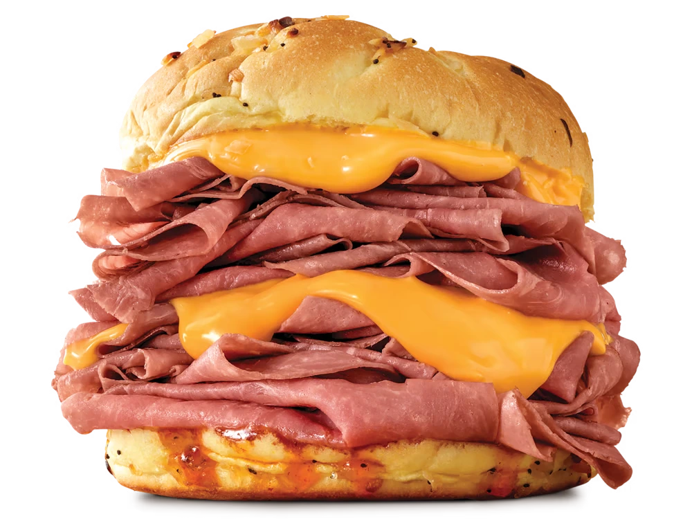 Arby's Half Pound Beef 'N Cheddar sandwich with roast beef, cheddar cheese sauce, and red ranch sauce on a toasted onion roll.