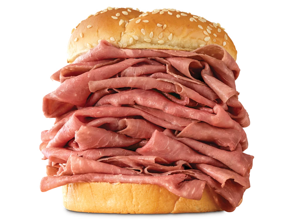 Arby's Half Pound Roast Beef sandwich with a generous serving of thinly sliced roast beef on a toasted sesame seed bun.