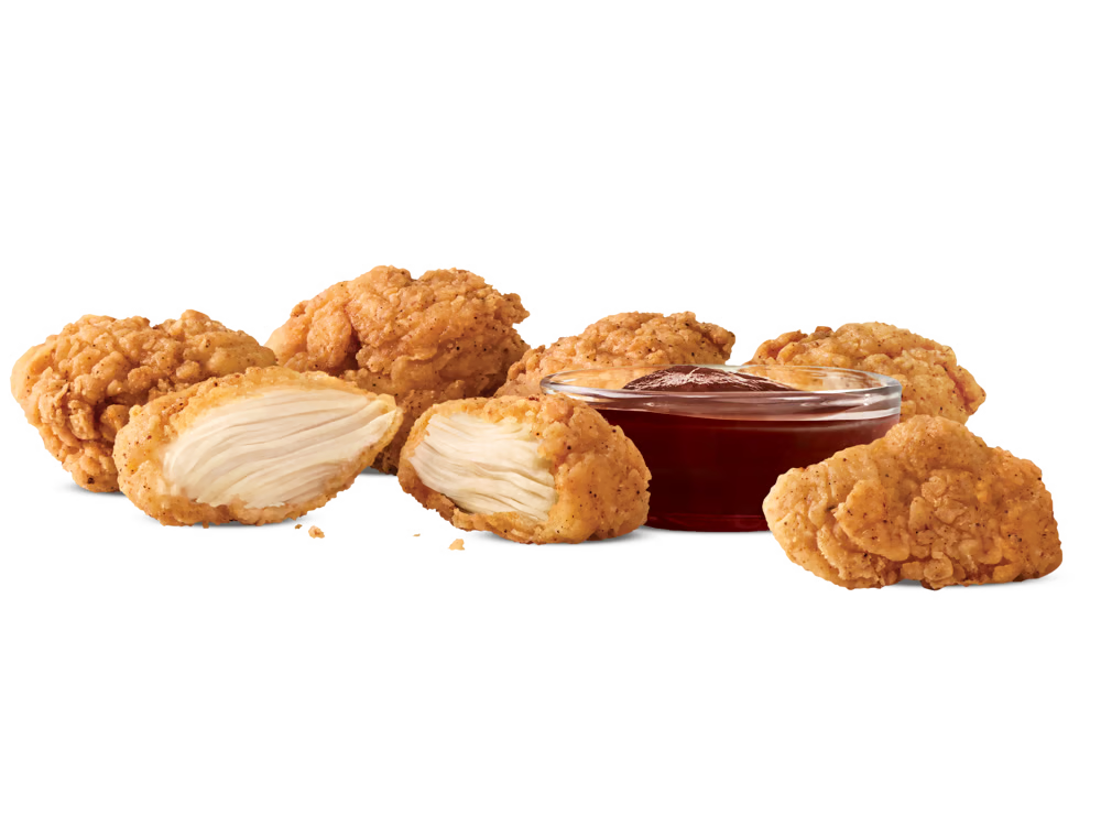 Arby's Premium 6PC Chicken Nuggets served with a side of dipping sauce.