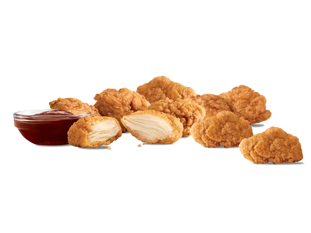 Arby's Premium 9-piece Chicken Nuggets with a side of dipping sauce.